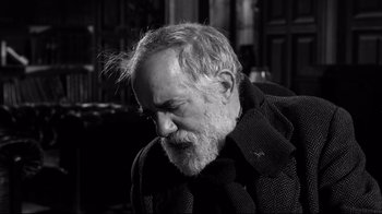 Movie still from “Viridiana” (1961), directed by Luis Buñuel – An old man with a beard and a jacket; Close Up shot, Low angle