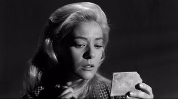 Movie still from “Viridiana” (1961), directed by Luis Buñuel – A black and white photo of a woman holding a piece of paper; Close Up shot, Low angle