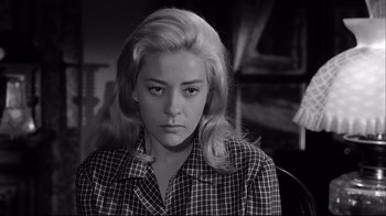 Movie still from “Viridiana” (1961), directed by Luis Buñuel – A black and white photo of a woman in a checkered shirt; Close Up shot, Low angle