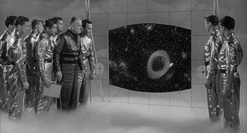 Movie still from “Visit to a Small Planet” (1960), directed by Norman Taurog – A black - and - white photo of a group of men standing next to each other; Extreme Wide shot, High angle
