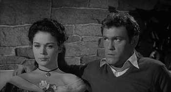 Movie still from “Visit to a Small Planet” (1960), directed by Norman Taurog – A man and a woman standing next to a brick wall; Close Up shot, High angle