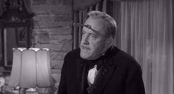 Movie still from “Visit to a Small Planet” (1960), directed by Norman Taurog – An older man in a suit and tie with a cigarette in his mouth; Close Up shot, Over the shoulder angle