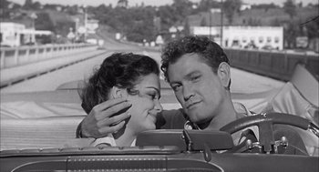 Movie still from “Visit to a Small Planet” (1960), directed by Norman Taurog – A man and a woman sitting next to each other in a car; Close Up shot, High angle