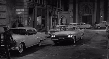 Movie still from “Visit to a Small Planet” (1960), directed by Norman Taurog – A black and white photo of cars on a city street; Wide shot, High angle