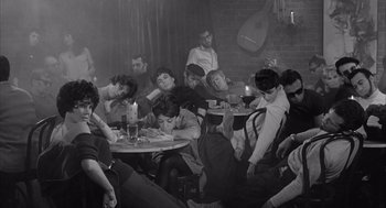 Movie still from “Visit to a Small Planet” (1960), directed by Norman Taurog – A group of people sitting at a table in a room; Wide shot, High angle