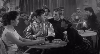 Movie still from “Visit to a Small Planet” (1960), directed by Norman Taurog – A group of young men sitting around a table; Medium shot, High angle
