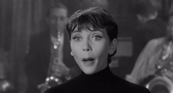 Movie still from “Visit to a Small Planet” (1960), directed by Norman Taurog – A black - and - white photo of a woman with a surprised look on her face; Close Up shot, Over the shoulder angle