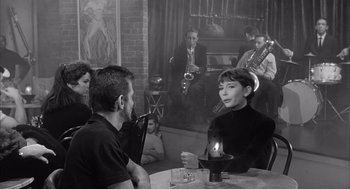 Movie still from “Visit to a Small Planet” (1960), directed by Norman Taurog – A group of people sitting around a table; Medium shot, Over the shoulder angle