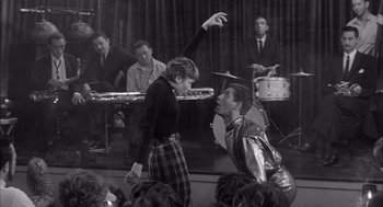 Movie still from “Visit to a Small Planet” (1960), directed by Norman Taurog – A man and a woman dancing in front of an audience; Medium shot, Low angle