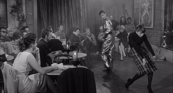 Movie still from “Visit to a Small Planet” (1960), directed by Norman Taurog – A group of people sitting around a table; Wide shot, Low angle