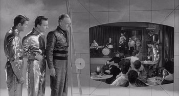 Movie still from “Visit to a Small Planet” (1960), directed by Norman Taurog – A black - and - white photo of a group of people in a room; Wide shot, High angle