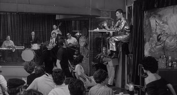 Movie still from “Visit to a Small Planet” (1960), directed by Norman Taurog – A group of people sitting and standing in a room; Wide shot, Low angle