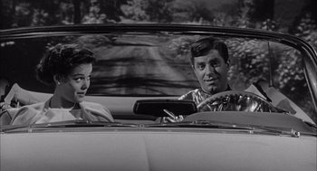 Movie still from “Visit to a Small Planet” (1960), directed by Norman Taurog – A man and a woman in the back seat of a car; Medium shot, Over the shoulder angle