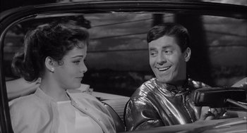 Movie still from “Visit to a Small Planet” (1960), directed by Norman Taurog – A man and a woman sitting in the back of a car; Medium shot, Over the shoulder angle