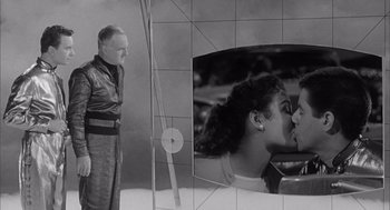 Movie still from “Visit to a Small Planet” (1960), directed by Norman Taurog – A man standing in front of a tv with a picture on the wall; Medium shot, Over the shoulder angle