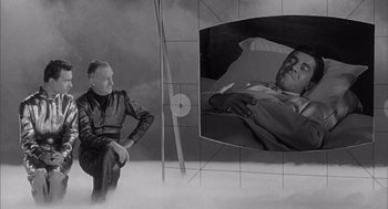 Movie still from “Visit to a Small Planet” (1960), directed by Norman Taurog – An old man sitting in front of a mirror; Wide shot, High angle