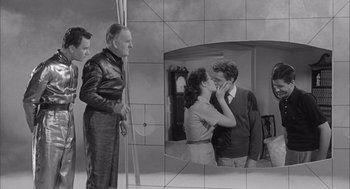 Movie still from “Visit to a Small Planet” (1960), directed by Norman Taurog – A man and a woman kissing in front of a mirror; Medium shot, Over the shoulder angle