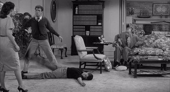 Movie still from “Visit to a Small Planet” (1960), directed by Norman Taurog – Three men in a living room playing a video game; Wide shot, High angle
