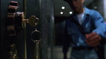 Movie still from “Vive L'Amour” (1994), directed by Tsai Ming-liang – A man standing next to a door with a bunch of keys hanging from it; Extreme Close Up shot, Overhead angle