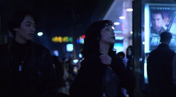 Movie still from “Vive L'Amour” (1994), directed by Tsai Ming-liang – A woman standing in the dark looking up at the sky; Medium shot, Over the shoulder angle