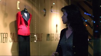 Movie still from “Vive L'Amour” (1994), directed by Tsai Ming-liang – A woman standing in front of a store window; Medium shot, Over the shoulder angle