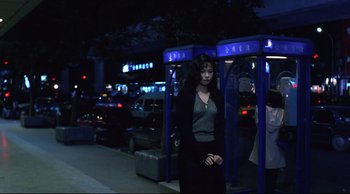 Movie still from “Vive L'Amour” (1994), directed by Tsai Ming-liang – A woman standing on the side of the street at night; Wide shot, Low angle