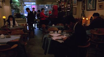 Movie still from “Vive L'Amour” (1994), directed by Tsai Ming-liang – A man sitting at a table in a restaurant; Wide shot, High angle