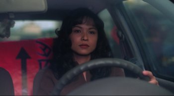 Movie still from “Vive L'Amour” (1994), directed by Tsai Ming-liang – A woman sitting in the driver's seat of a car; Close Up shot, Low angle