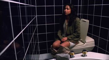 Movie still from “Vive L'Amour” (1994), directed by Tsai Ming-liang – A woman sitting on a toilet in a bathroom; Medium shot, High angle