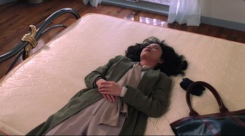 Movie still from “Vive L'Amour” (1994), directed by Tsai Ming-liang – A woman laying on top of a mattress on top of a wooden floor; Medium shot, High angle