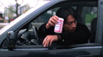 Movie still from “Vive L'Amour” (1994), directed by Tsai Ming-liang – A man sitting in the driver's seat of a car; Close Up shot, Low angle
