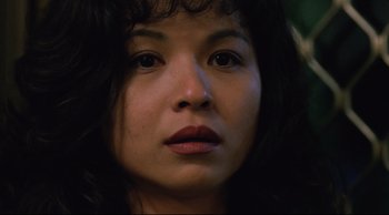 Movie still from “Vive L'Amour” (1994), directed by Tsai Ming-liang – A woman's face in a dark room; Close Up shot, Over the shoulder angle
