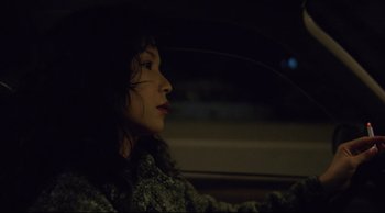 Movie still from “Vive L'Amour” (1994), directed by Tsai Ming-liang – A woman sitting in the driver's seat of a car at night; Close Up shot, Low angle