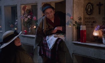 Movie still from “Voice of the Moon” (1990), directed by Richard Stanley – An old man standing in front of a window; Medium shot, High angle