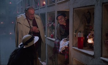 Movie still from “Voice of the Moon” (1990), directed by Richard Stanley – Two older men standing next to each other; Medium shot, High angle