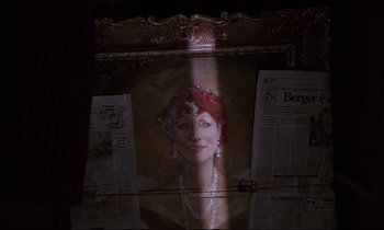 Movie still from “Voice of the Moon” (1990), directed by Richard Stanley – A painting of a woman with a pearl necklace; Extreme Close Up shot, Low angle