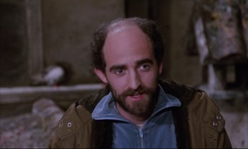 Movie still from “Voice of the Moon” (1990), directed by Richard Stanley – A man with a bald head and a beard; Close Up shot, High angle