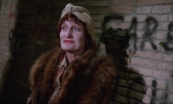 Movie still from “Voice of the Moon” (1990), directed by Richard Stanley – An older woman wearing a fur coat and a hat; Close Up shot, Low angle
