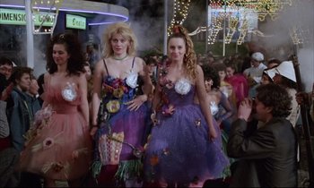 Movie still from “Voice of the Moon” (1990), directed by Richard Stanley – A couple of people that are dressed up; Medium shot, Low angle