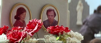 Movie still from “Volver” (2006), directed by Pedro Almodóvar – A picture of a man in a frame next to flowers in a vase; Extreme Close Up shot, Overhead angle