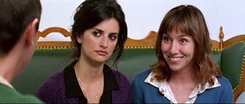 Movie still from “Volver” (2006), directed by Pedro Almodóvar – Two women standing next to each other in front of a green wall; Close Up shot, Over the shoulder angle