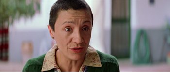 Movie still from “Volver” (2006), directed by Pedro Almodóvar – A person with short black hair; Close Up shot, Over the shoulder angle