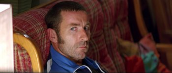 Movie still from “Volver” (2006), directed by Pedro Almodóvar – A person sitting on a couch; Close Up shot, Over the shoulder angle