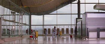 Movie still from “Volver” (2006), directed by Pedro Almodóvar – Two people are cleaning the floor of a building; Extreme Wide shot, Low angle
