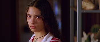 Movie still from “Volver” (2006), directed by Pedro Almodóvar – A woman with long black hair wearing a red and white striped shirt; Close Up shot, High angle