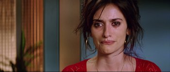 Movie still from “Volver” (2006), directed by Pedro Almodóvar – A person with a crying look on their face; Close Up shot, Over the shoulder angle