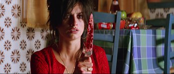 Movie still from “Volver” (2006), directed by Pedro Almodóvar – A woman holding a bloody knife in her hand; Close Up shot, Low angle