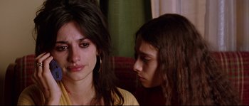 Movie still from “Volver” (2006), directed by Pedro Almodóvar – A woman sitting next to another woman on a couch; Close Up shot, Over the shoulder angle