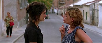 Movie still from “Volver” (2006), directed by Pedro Almodóvar – Two women talking on the side of the street; Close Up shot, Over the shoulder angle