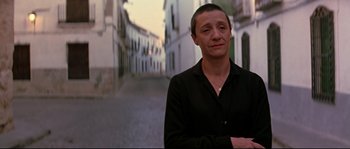Movie still from “Volver” (2006), directed by Pedro Almodóvar – A woman standing in a street with her arms crossed; Close Up shot, Low angle